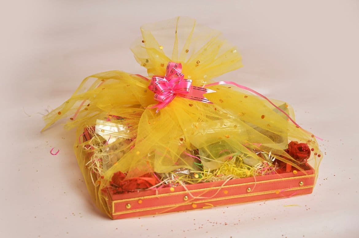 A curated gift hamper with assorted packaged items and ribbon details